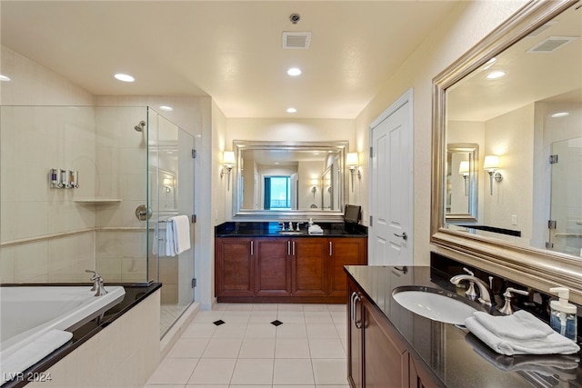 bathroom featuring tile patterned flooring, vanity, and plus walk in shower