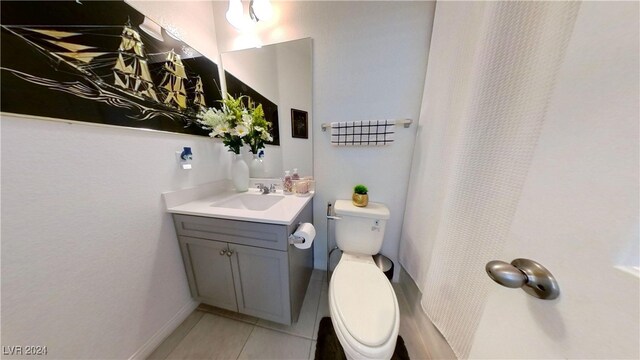 bathroom with tile patterned floors, vanity, and toilet