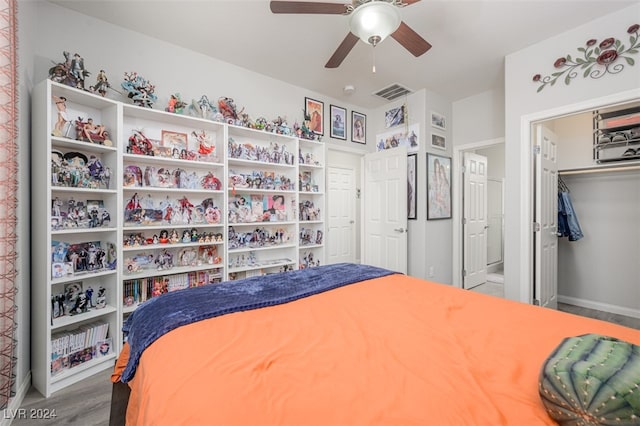 bedroom with hardwood / wood-style floors, ceiling fan, and a closet