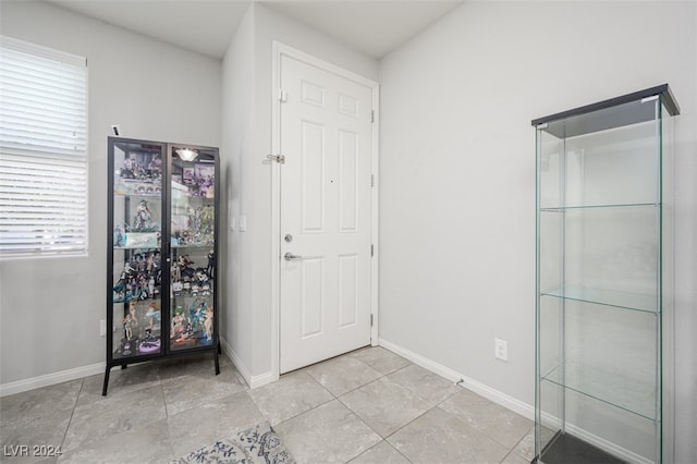 entryway with light tile patterned floors