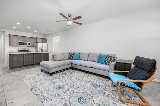 living room featuring ceiling fan and light tile patterned flooring