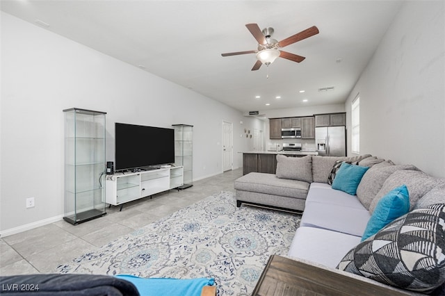 tiled living room with ceiling fan