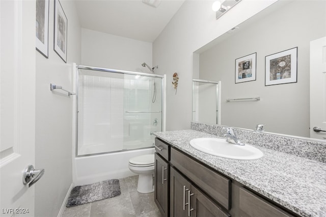 full bathroom featuring vanity, toilet, and bath / shower combo with glass door