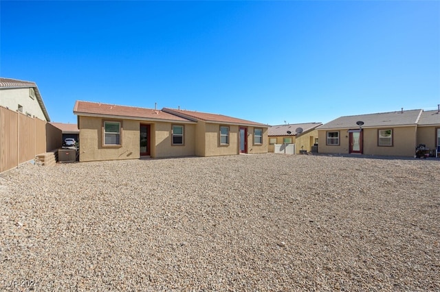 2675 Chinaberry Hill St, Laughlin, NV 89029 - back of house featuring fence, stucco siding, and central AC unit