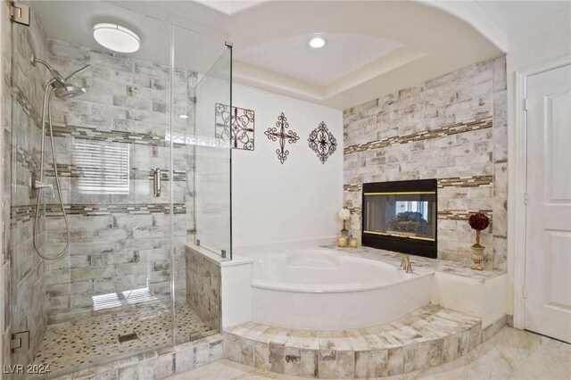 bathroom featuring shower with separate bathtub