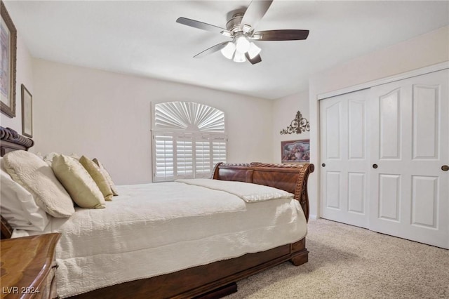 carpeted bedroom with ceiling fan and a closet