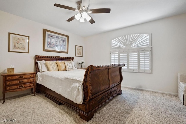 bedroom with ceiling fan and light colored carpet