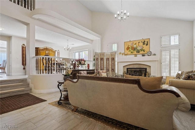 living room featuring a towering ceiling and a chandelier