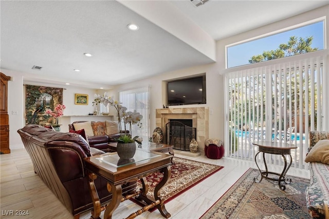 living room with a fireplace and plenty of natural light