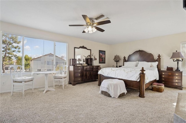 bedroom featuring ceiling fan and light carpet