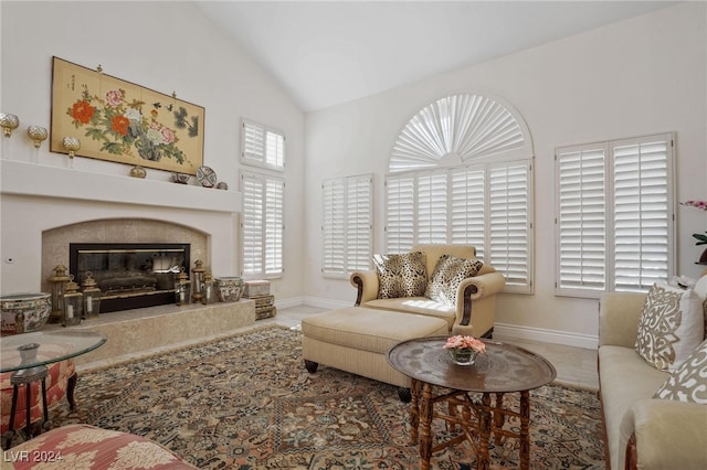 living room with a premium fireplace and vaulted ceiling