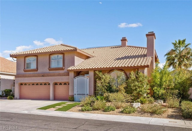 mediterranean / spanish-style home featuring a garage