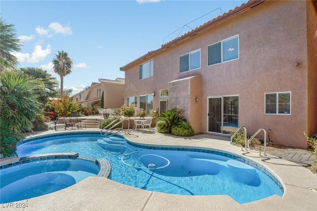 view of swimming pool with an in ground hot tub and a patio area