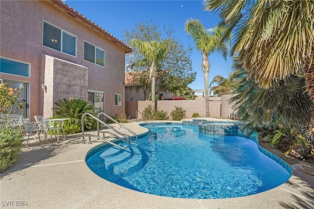 view of pool with an in ground hot tub and a patio