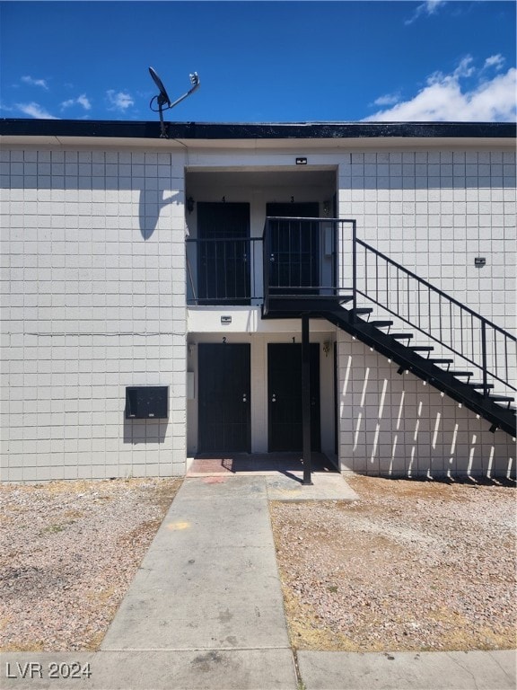 view of exterior entry with a balcony