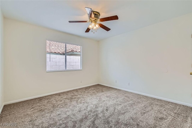 carpeted empty room featuring ceiling fan and baseboards