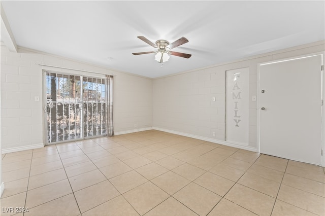 unfurnished room with light tile patterned floors, ceiling fan, and ornamental molding