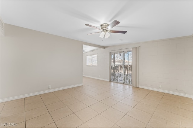 empty room with ceiling fan and light tile patterned flooring