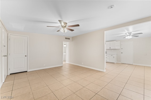 empty room featuring ceiling fan and light tile patterned flooring