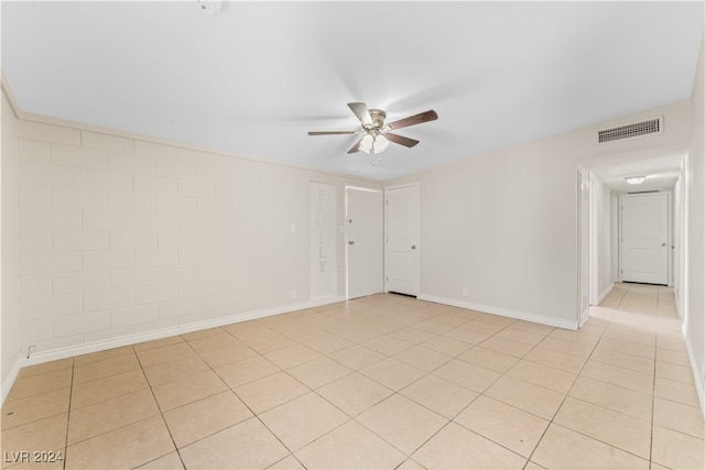 spare room with light tile patterned floors and ceiling fan