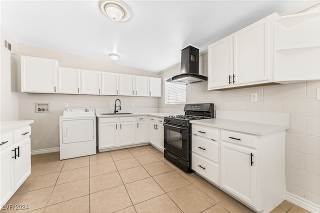 kitchen with wall chimney exhaust hood, sink, black gas stove, washer / dryer, and white cabinetry