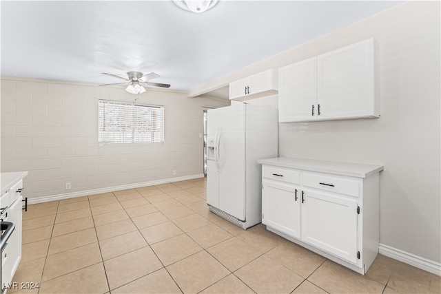 kitchen featuring white cabinets, ceiling fan, white fridge with ice dispenser, light tile patterned floors, and beamed ceiling