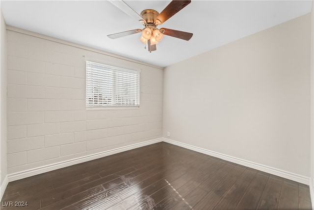 spare room featuring ceiling fan and dark wood-type flooring