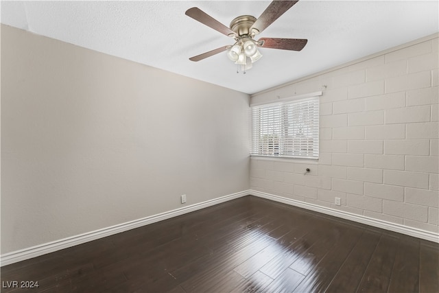 empty room featuring ceiling fan and dark wood-type flooring