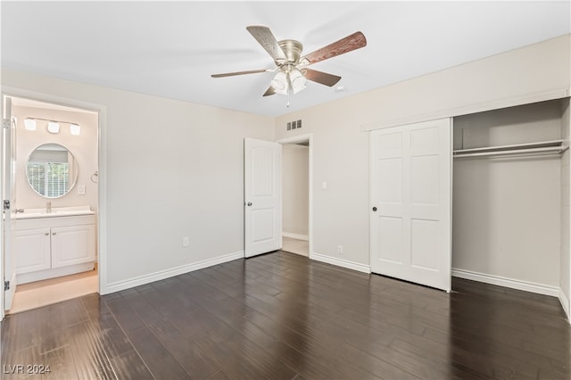 unfurnished bedroom with dark hardwood / wood-style flooring, a closet, ensuite bath, and ceiling fan