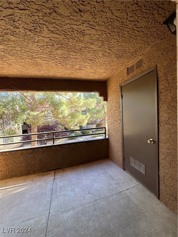 view of patio featuring a balcony