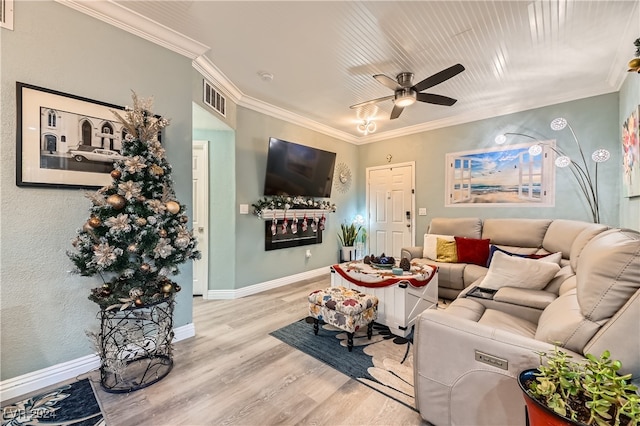 living room with light hardwood / wood-style floors, ceiling fan, and crown molding