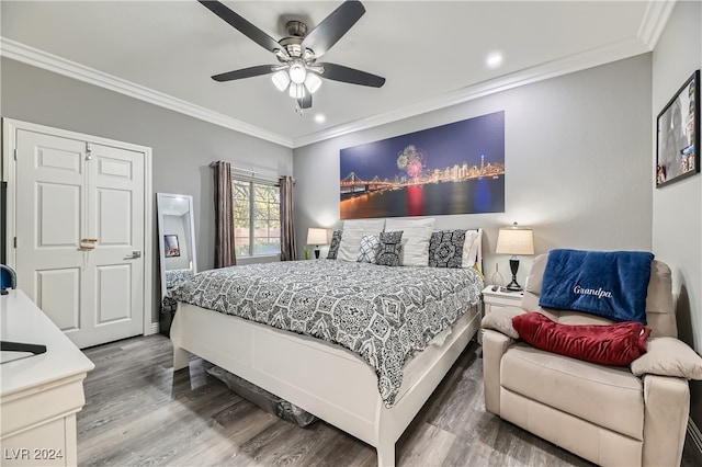 bedroom featuring ornamental molding, hardwood / wood-style flooring, and ceiling fan