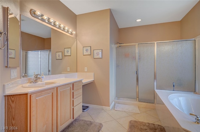 bathroom with tile patterned floors, vanity, and separate shower and tub