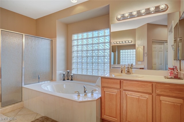 bathroom featuring tile patterned floors, vanity, and shower with separate bathtub