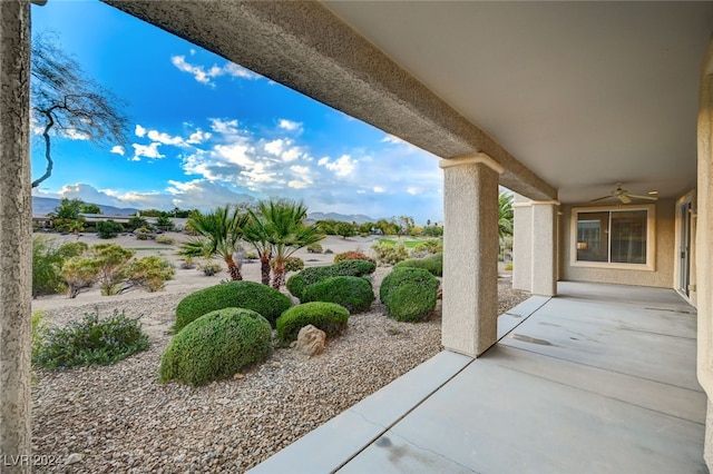 view of patio featuring a mountain view and ceiling fan