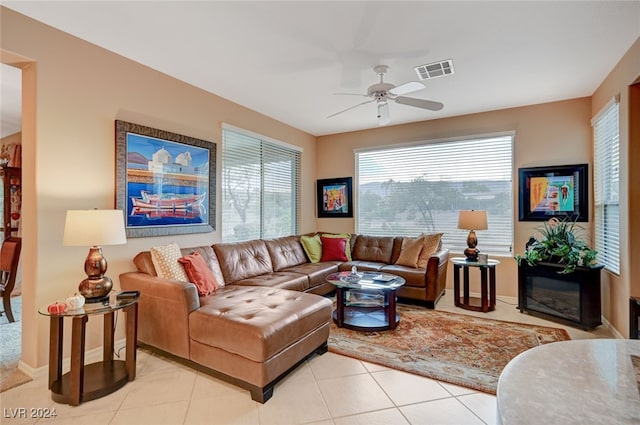 living room featuring ceiling fan and light tile patterned flooring