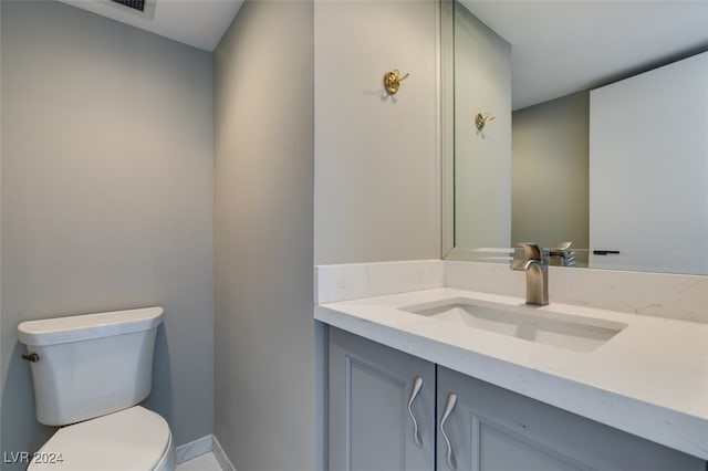 bathroom featuring toilet and vanity