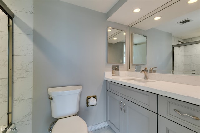 bathroom with vanity, toilet, and an enclosed shower