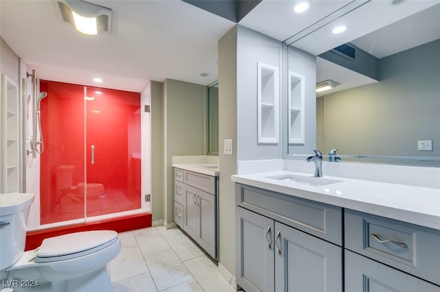 bathroom featuring an enclosed shower, vanity, and toilet