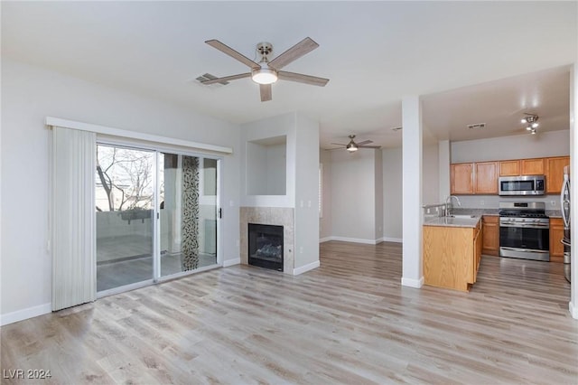 kitchen with open floor plan, light countertops, appliances with stainless steel finishes, and visible vents