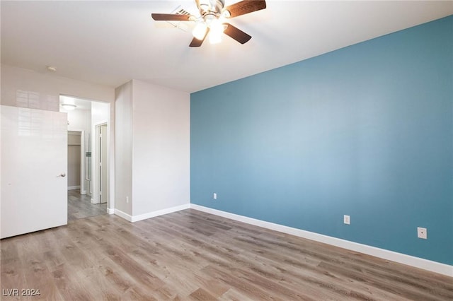 spare room with light wood-style flooring, baseboards, and a ceiling fan