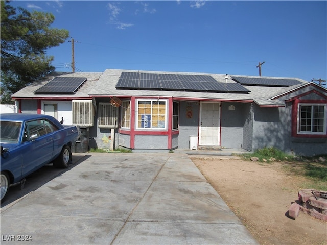 ranch-style home with solar panels