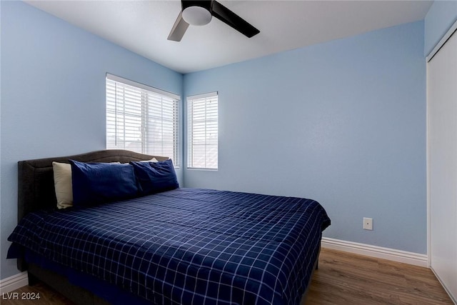 bedroom with ceiling fan and dark hardwood / wood-style floors