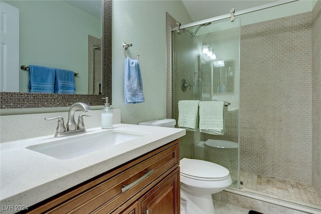 bathroom with vanity, toilet, and an enclosed shower