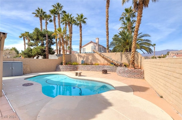 view of pool featuring a mountain view and a patio area