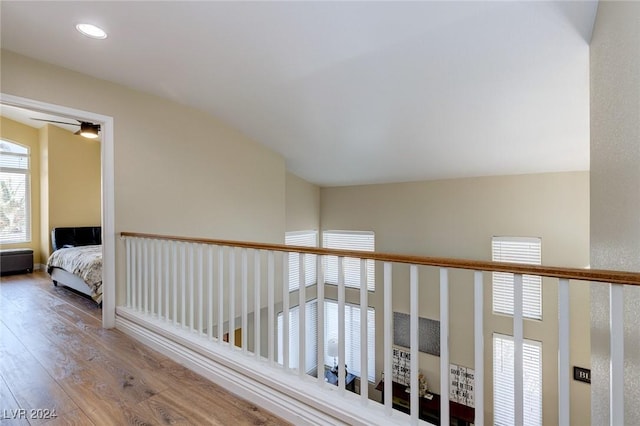 hallway featuring hardwood / wood-style flooring and vaulted ceiling