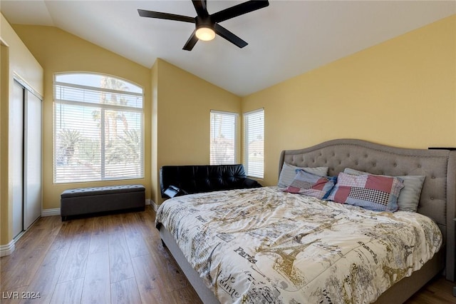 bedroom with ceiling fan, dark hardwood / wood-style flooring, and vaulted ceiling