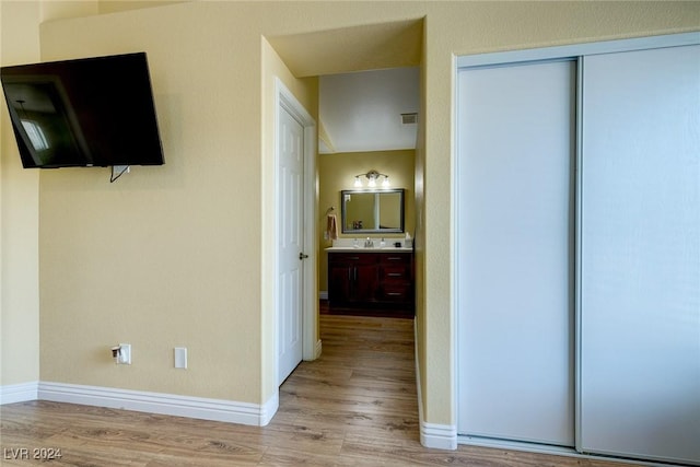 hallway with light hardwood / wood-style floors