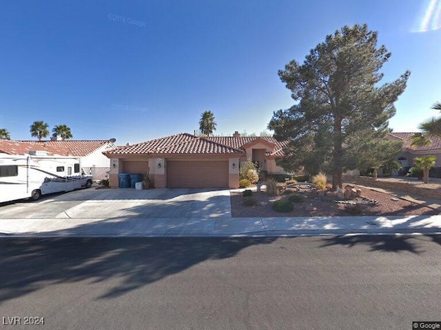 mediterranean / spanish house featuring a garage