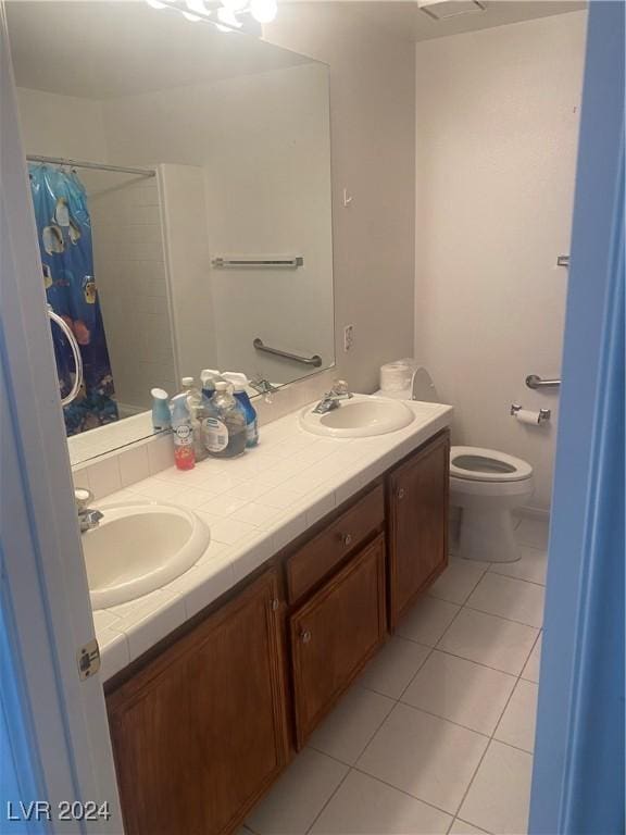 bathroom with toilet, tile patterned flooring, walk in shower, and vanity